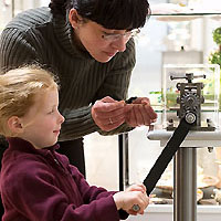 Besucher der Ausstellung versuchen sich an der Schmuck-Herstellung